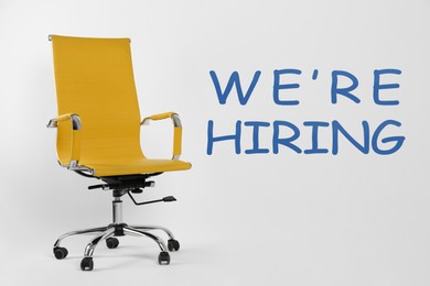 Image of We Are Hiring. Empty office chair on light background. Recruitment, human resources concept