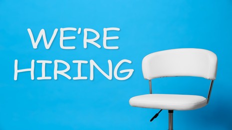 Image of We Are Hiring. Empty office chair on light blue background, banner. Recruitment, human resources concept