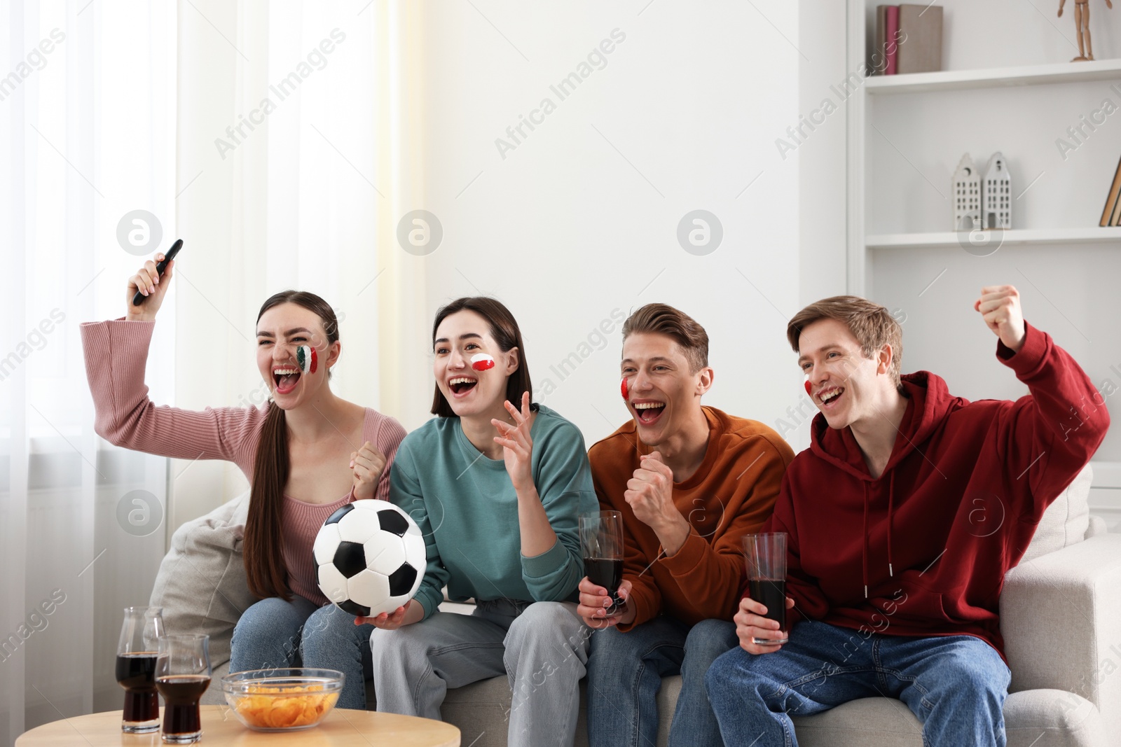 Emotional football fans watching game together indoors Photo of Emotional football fans watching game together indoors