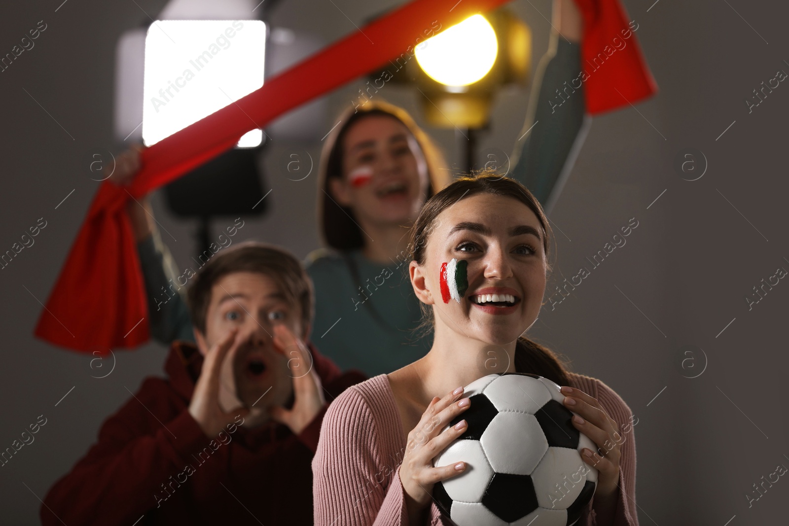 Emotional sports fans watching game together indoors, selective focus Photo of Emotional sports fans watching game together indoors, selective focus