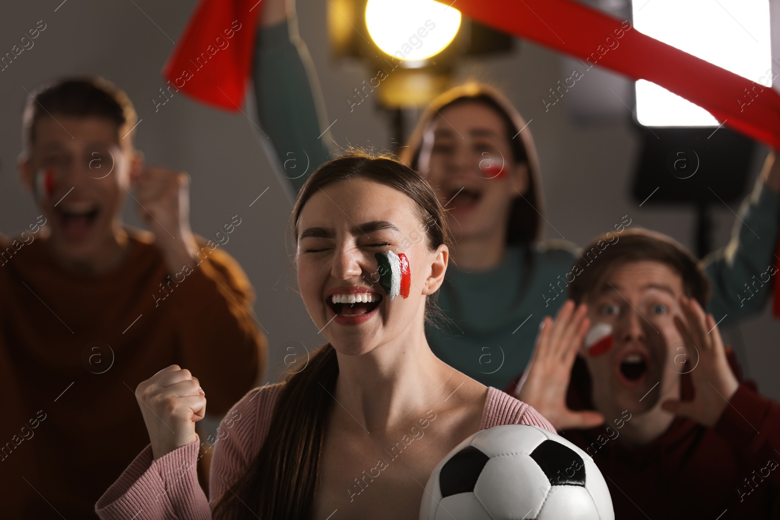 Emotional sports fans watching game together indoors, selective focus Photo of Emotional sports fans watching game together indoors, selective focus