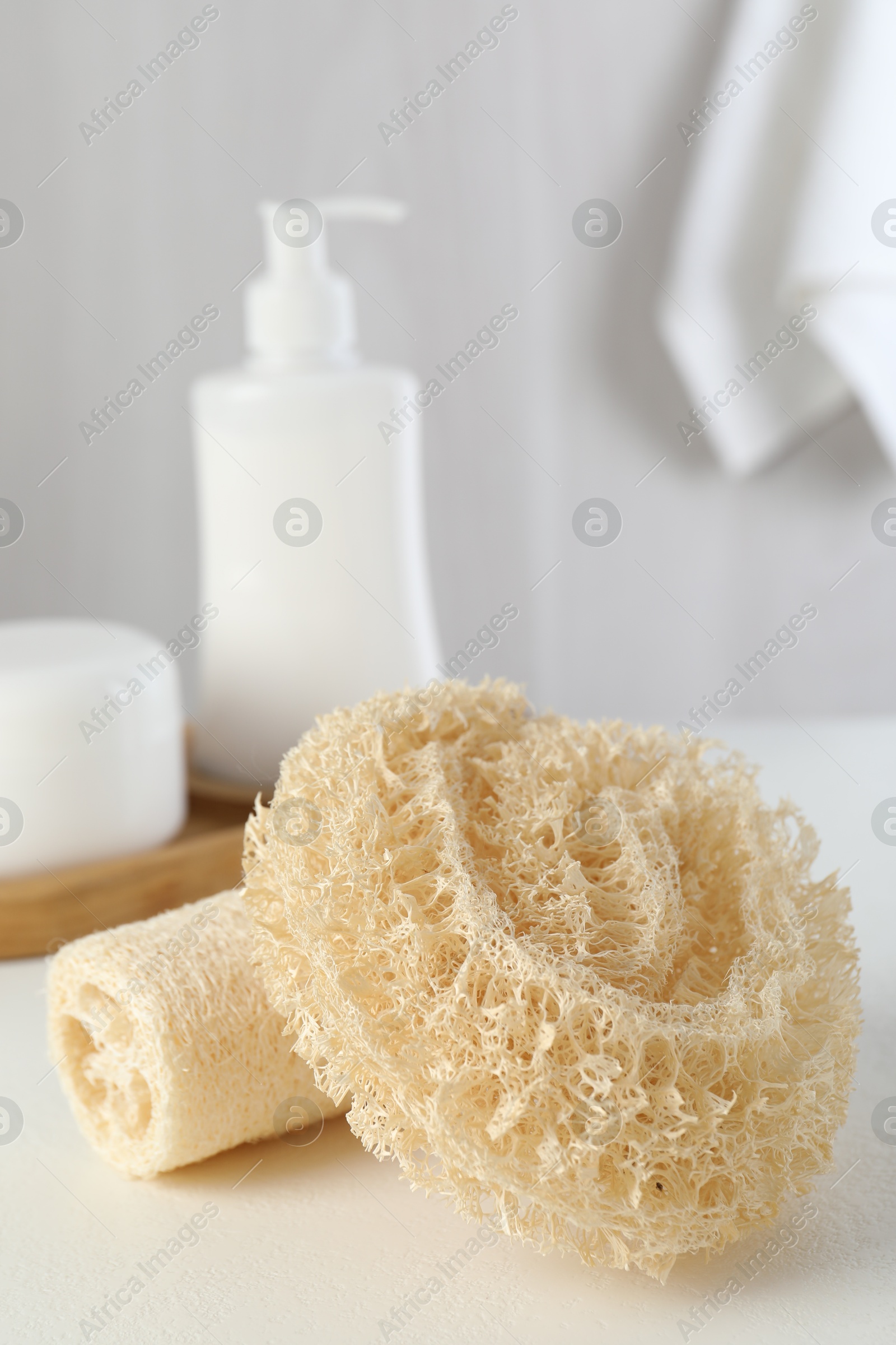 Different loofah sponges on white table, closeup Photo of Different loofah sponges on white table, closeup