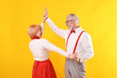 Photo of Lovely senior couple together on yellow background