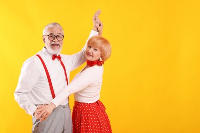Photo of Lovely senior couple together on yellow background, space for text