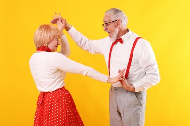 Photo of Lovely senior couple together on yellow background