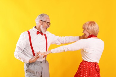 Photo of Lovely senior couple together on yellow background