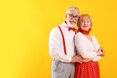 Photo of Lovely senior couple together on yellow background, space for text