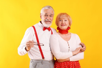Photo of Lovely senior couple together on yellow background