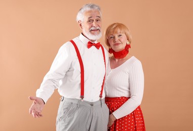 Photo of Lovely senior couple together on light brown background
