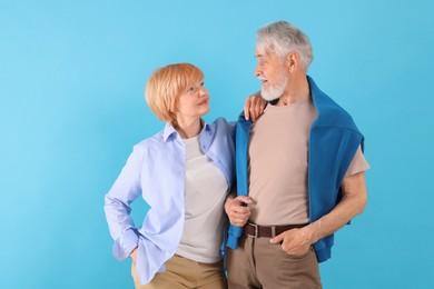Photo of Lovely senior couple together on light blue background