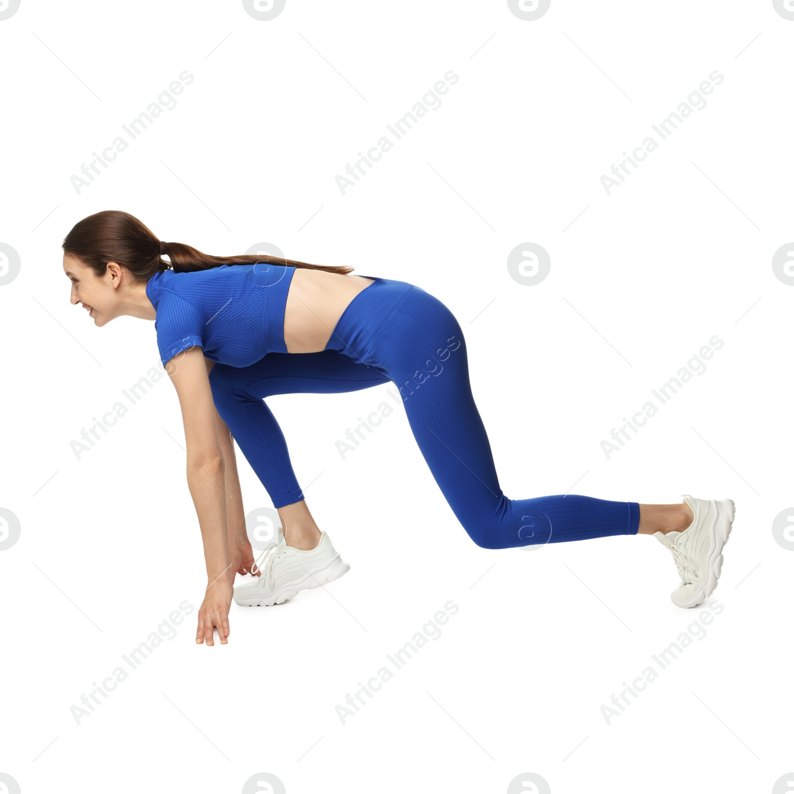 Runner in starting position on white background Photo of Runner in starting position on white background