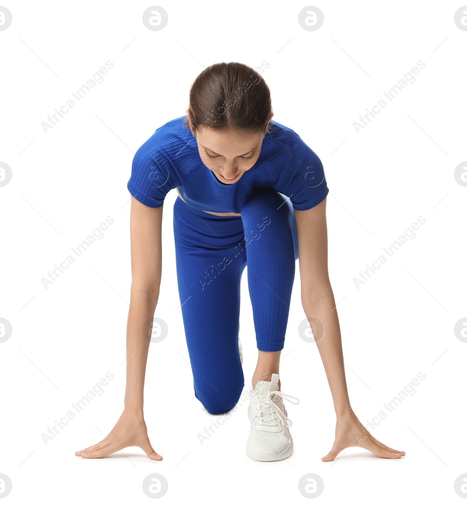 Runner in starting position on white background Photo of Runner in starting position on white background