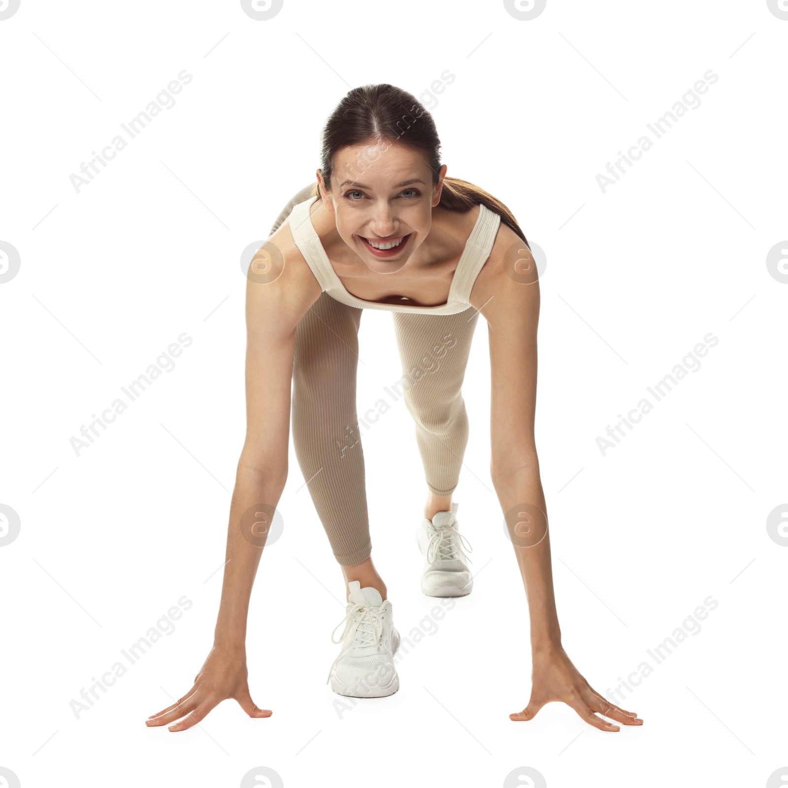 Runner in starting position on white background Photo of Runner in starting position on white background