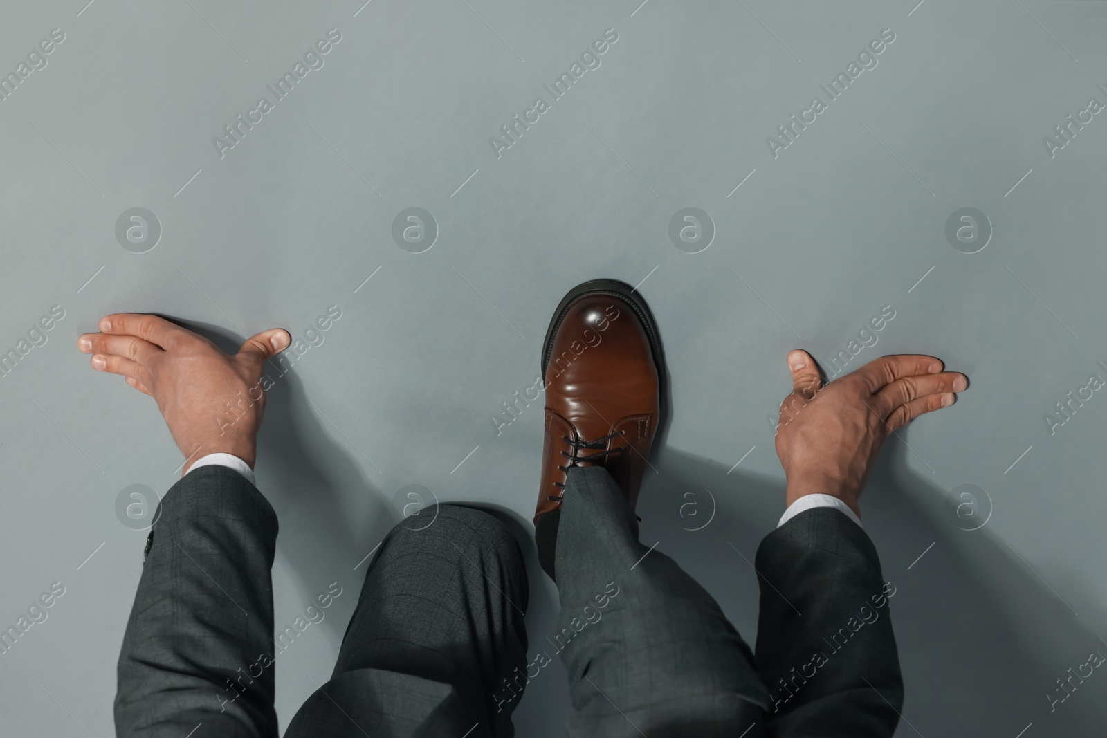 Businessman in starting position on gray background, top view Photo of Businessman in starting position on gray background, top view