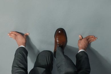 Photo of Businessman in starting position on gray background, top view