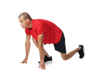 Photo of Runner in starting position on white background