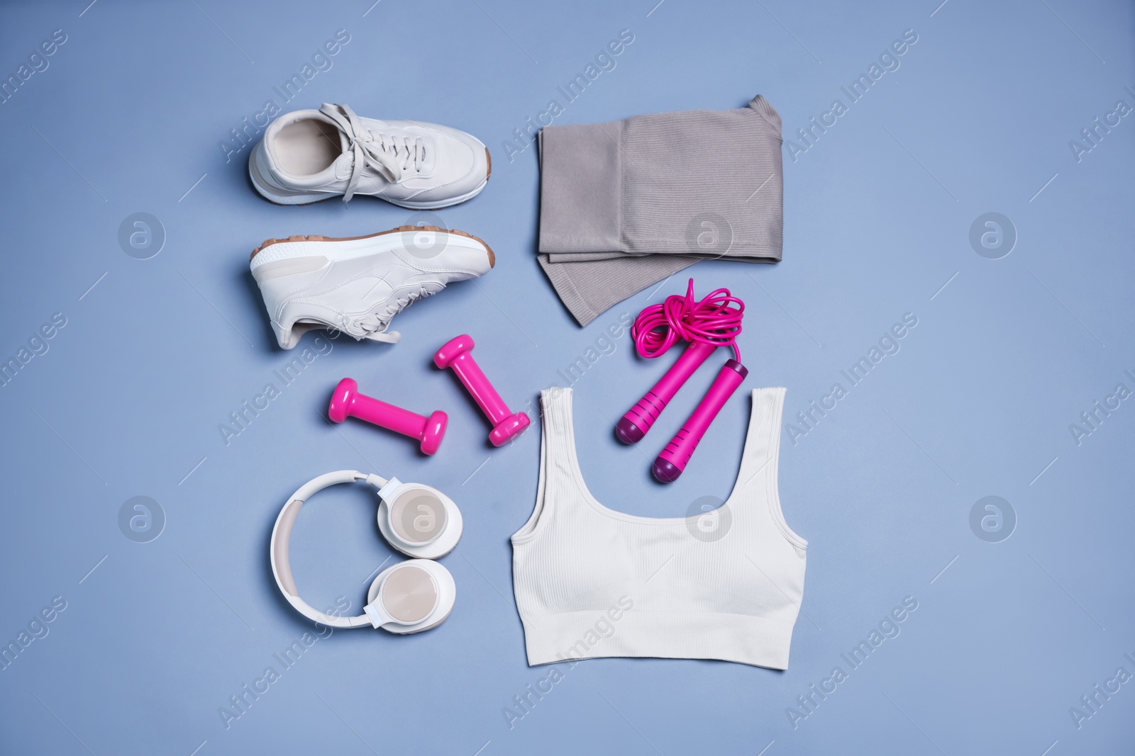 Sportswear, sneakers, skipping rope, headphones and dumbbells on grey background, flat lay Photo of Sportswear, sneakers, skipping rope, headphones and dumbbells on grey background, flat lay