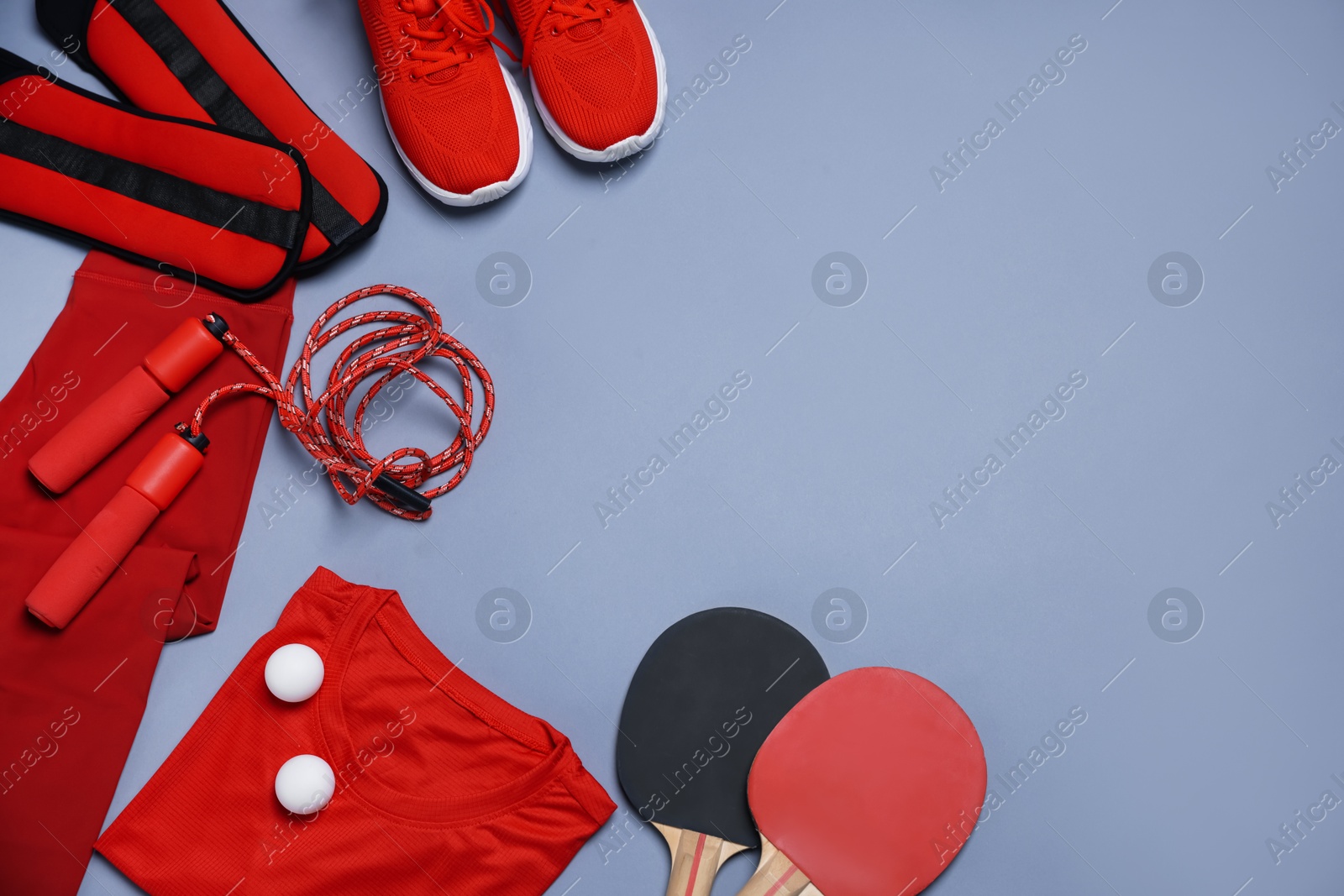 Flat lay composition with sportswear on grey background, space for text Photo of Flat lay composition with sportswear on grey background, space for text