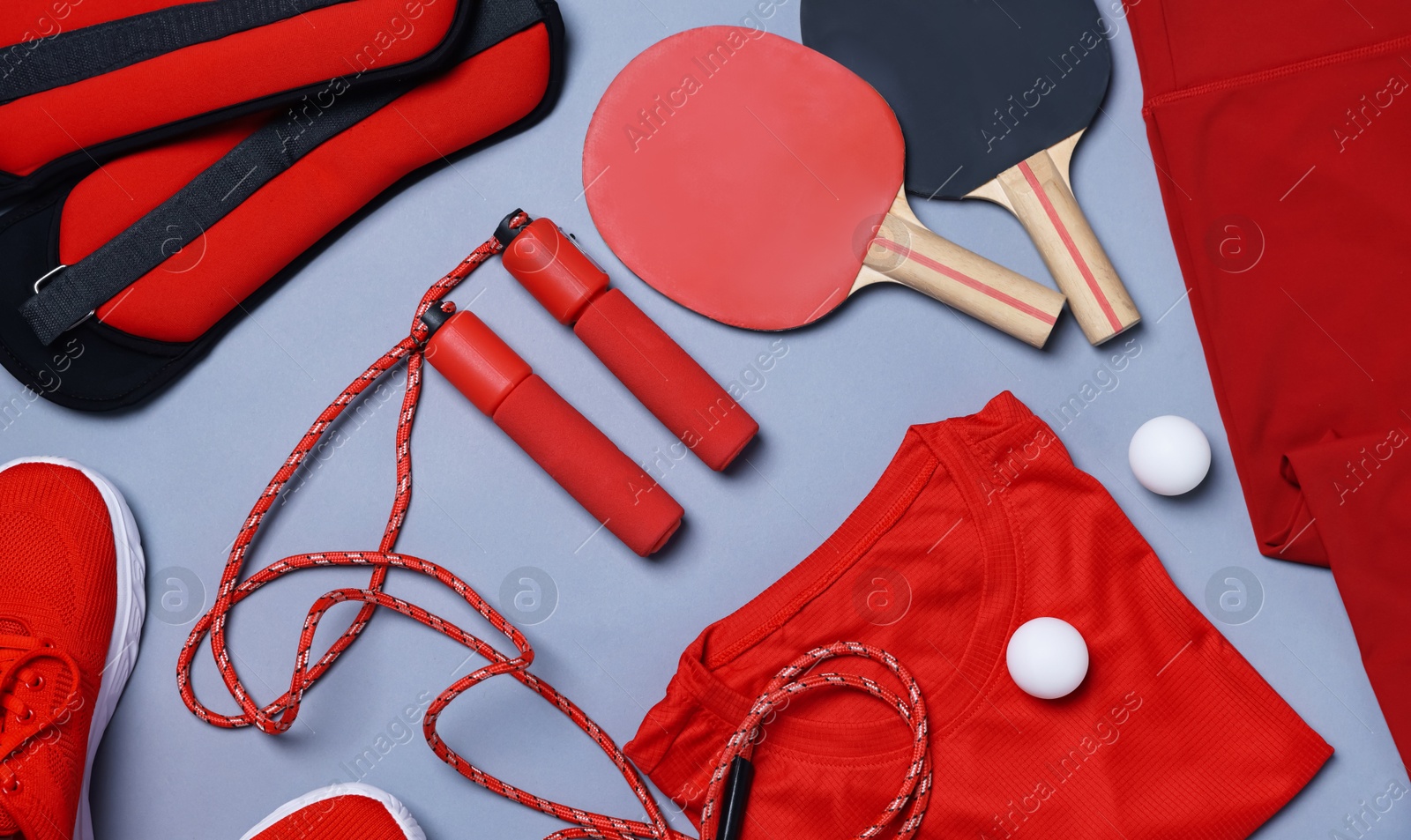 Flat lay composition with sportswear on grey background Photo of Flat lay composition with sportswear on grey background