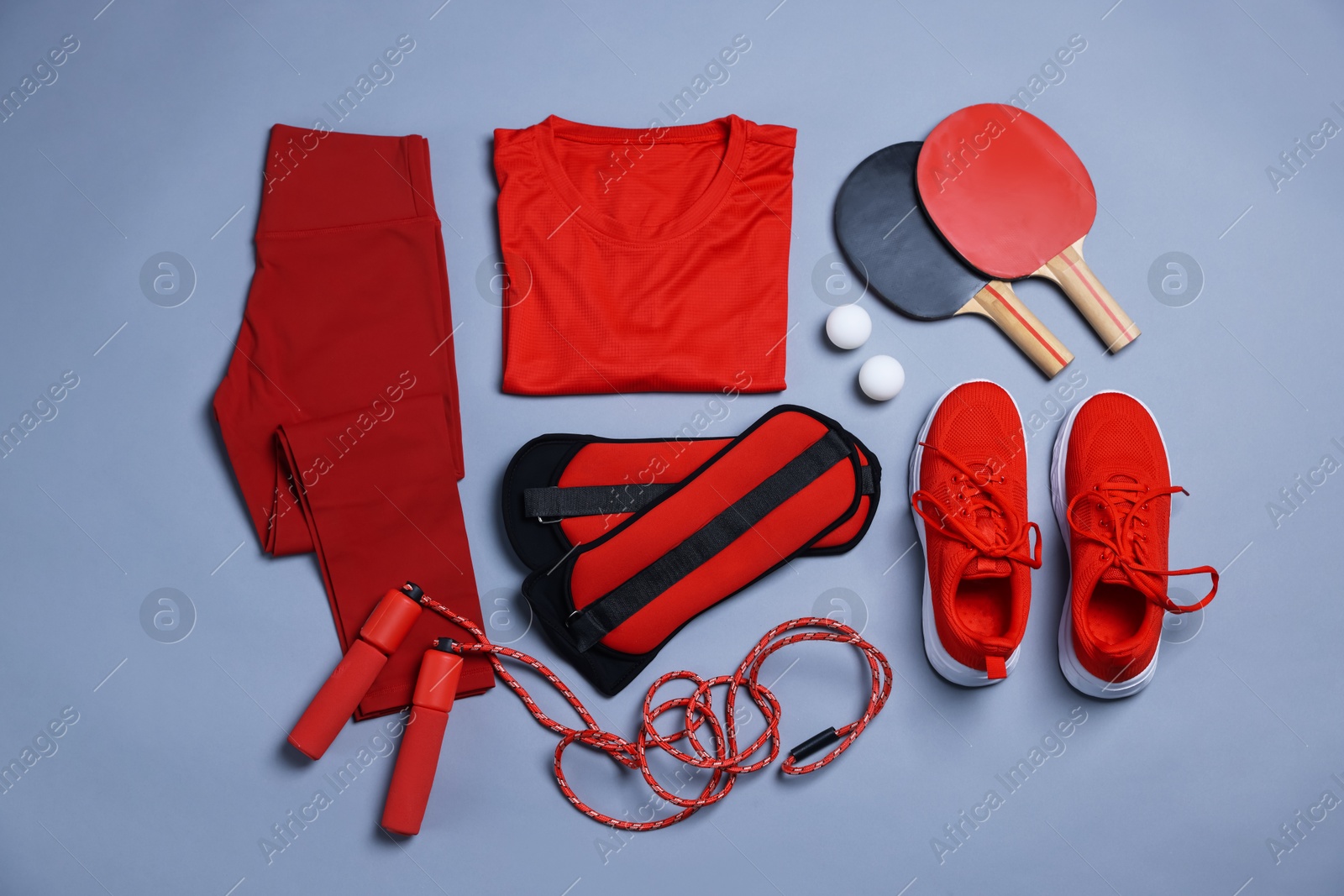 Flat lay composition with sportswear on grey background Photo of Flat lay composition with sportswear on grey background
