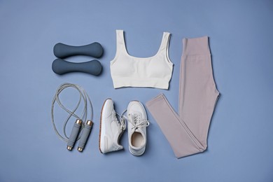 Photo of Sportswear, sneakers, skipping rope and dumbbells on grey background, flat lay