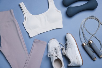 Photo of Sportswear, sneakers, skipping rope and dumbbells on grey background, flat lay