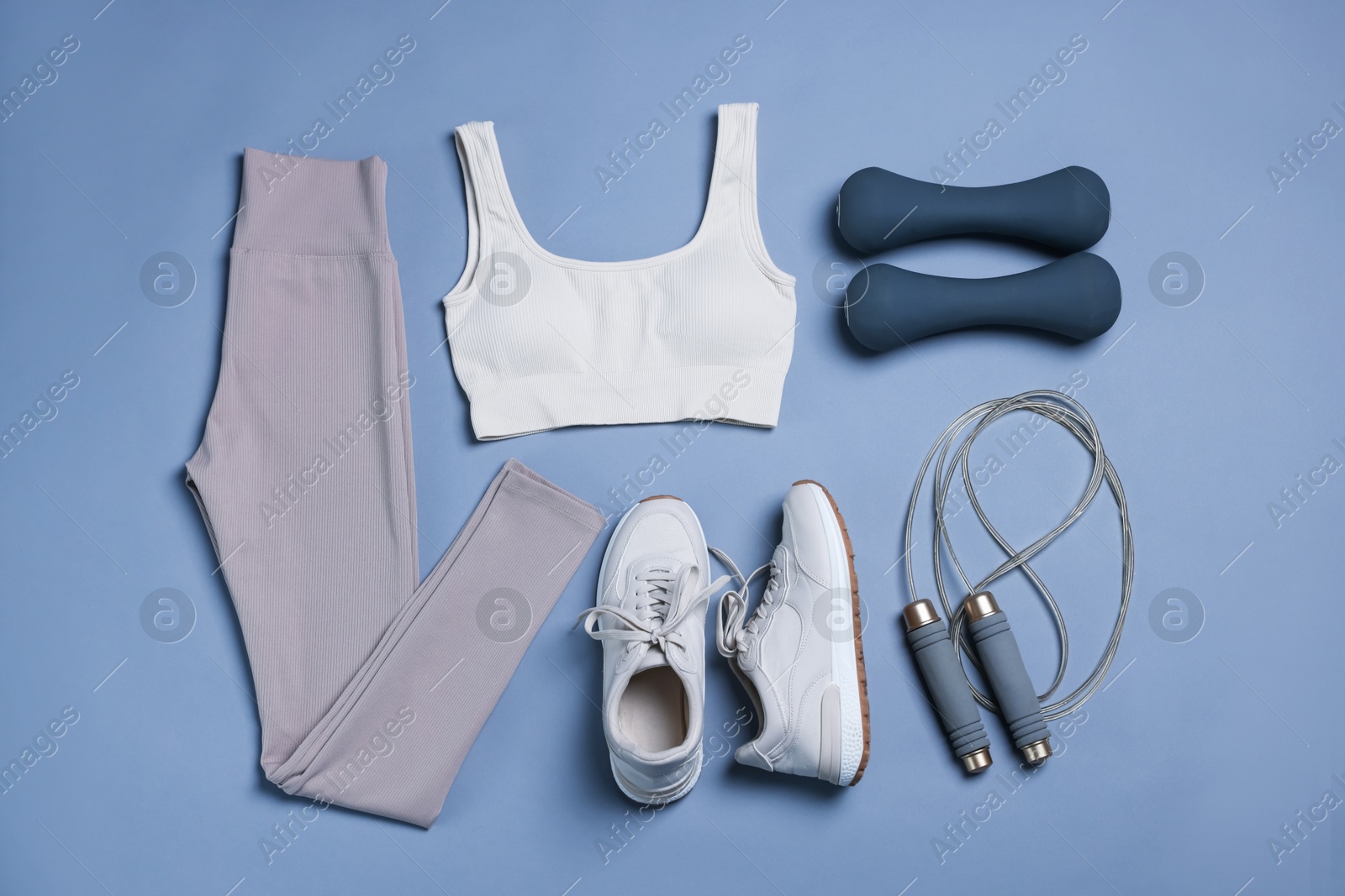 Sportswear, sneakers, skipping rope and dumbbells on grey background, flat lay Photo of Sportswear, sneakers, skipping rope and dumbbells on grey background, flat lay