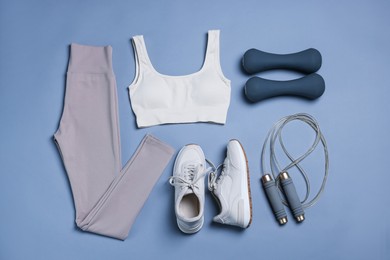 Photo of Sportswear, sneakers, skipping rope and dumbbells on grey background, flat lay
