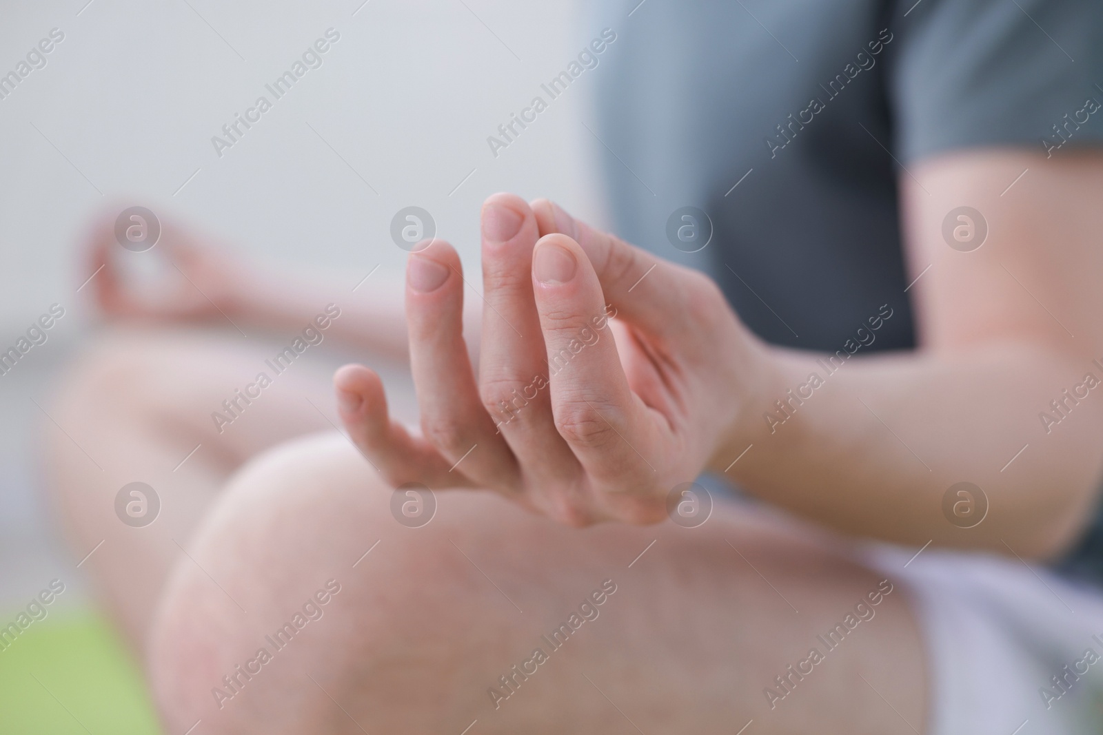 Young man practicing yoga at home, closeup Photo of Young man practicing yoga at home, closeup