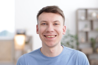 Photo of Portrait of cheerful young man at home