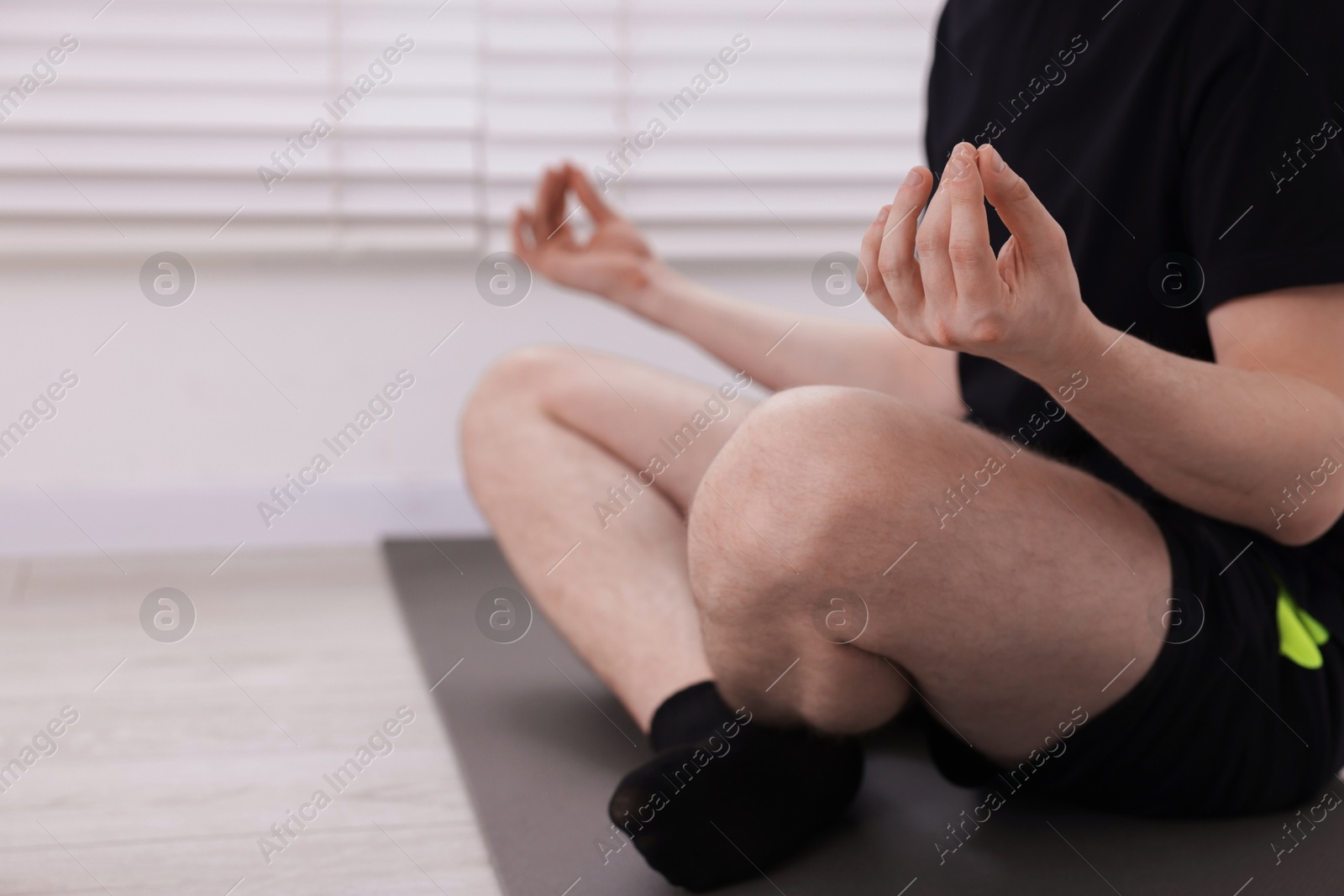 Young man practicing yoga at home, closeup Photo of Young man practicing yoga at home, closeup