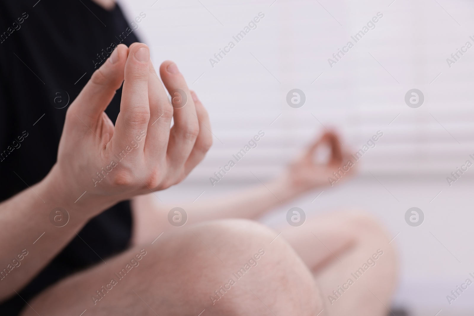 Young man practicing yoga at home, closeup Photo of Young man practicing yoga at home, closeup