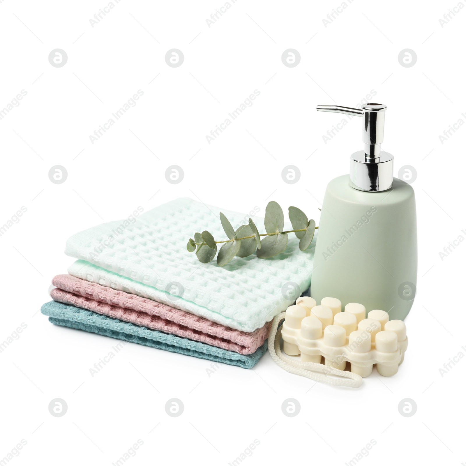 Clean waffle towels, soap and eucalyptus isolated on white Photo of Clean waffle towels, soap and eucalyptus isolated on white