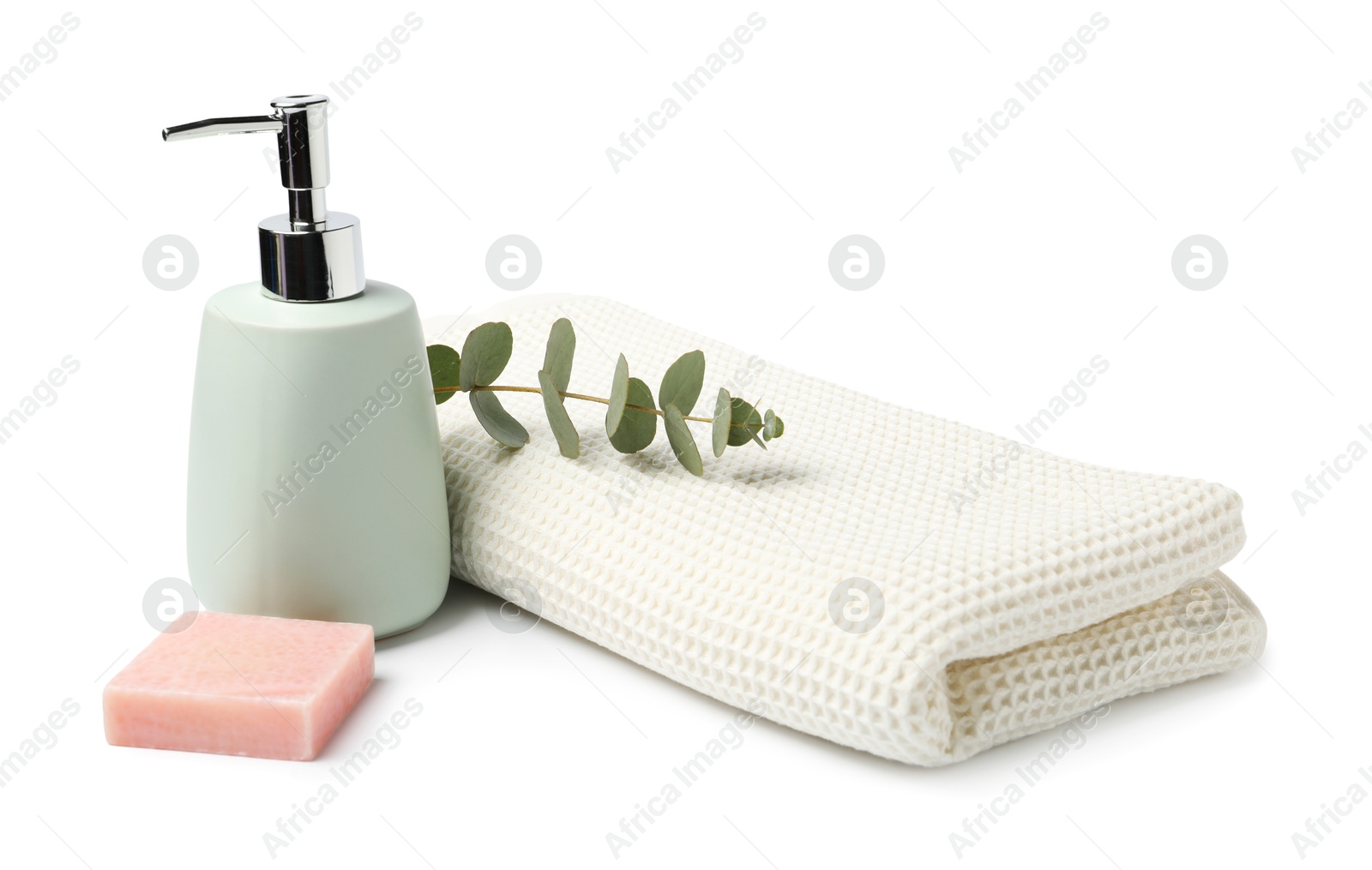 Photo of Clean waffle towel, soap and eucalyptus isolated on white