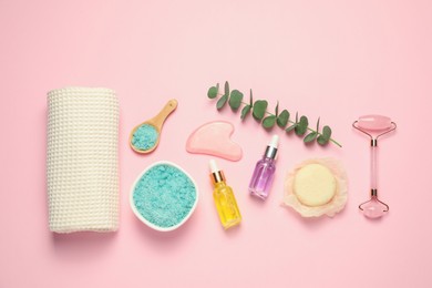 Photo of Clean waffle towel and cosmetic products on light pink background, flat lay