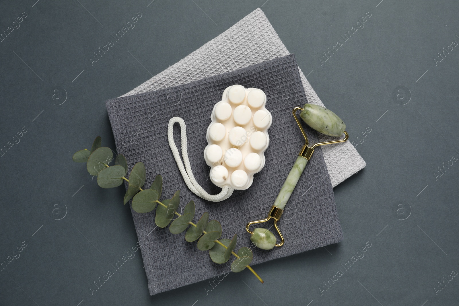 Clean waffle towels and cosmetic products on grey background, flat lay Photo of Clean waffle towels and cosmetic products on grey background, flat lay