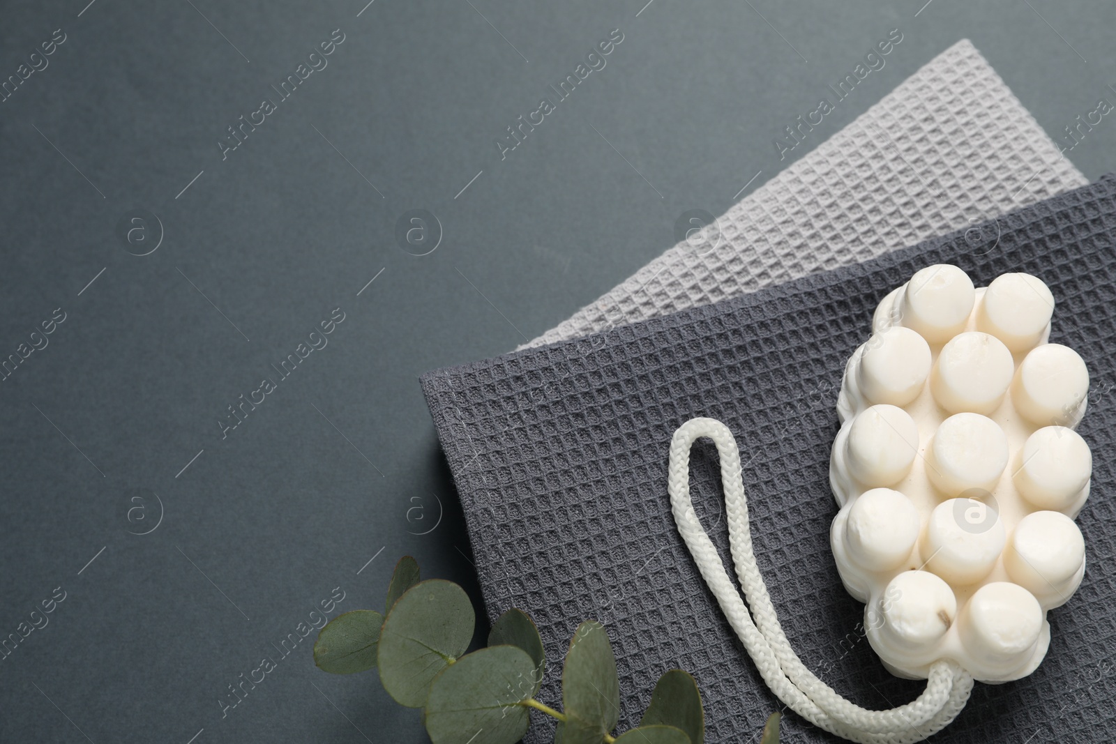 Clean waffle towels and cosmetic products on grey background, flat lay. Space for text Photo of Clean waffle towels and cosmetic products on grey background, flat lay. Space for text
