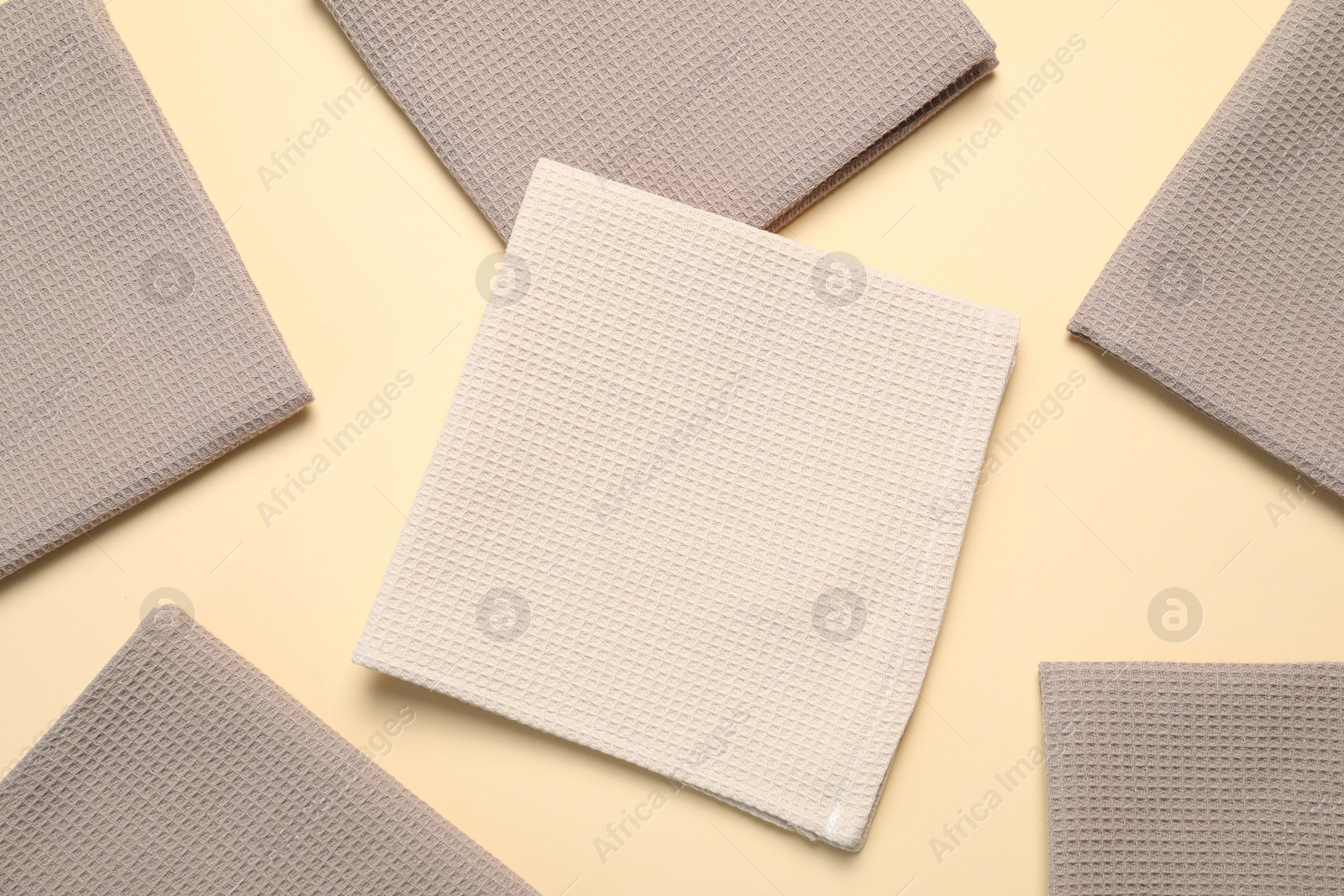 Clean waffle towels on beige background, flat lay Photo of Clean waffle towels on beige background, flat lay