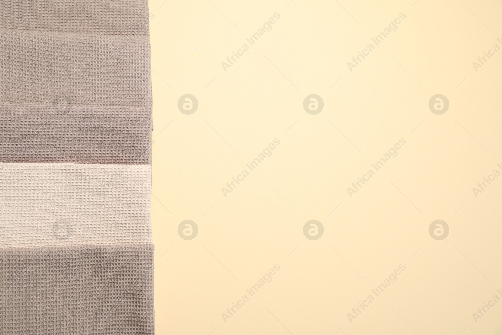Clean waffle towels on beige background, flat lay. Space for text Photo of Clean waffle towels on beige background, flat lay. Space for text
