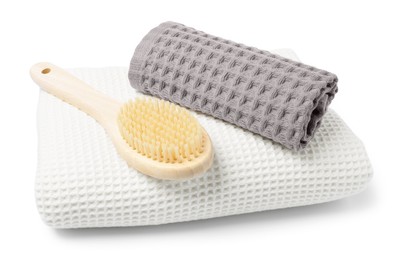 Photo of Clean waffle towels and brush isolated on white