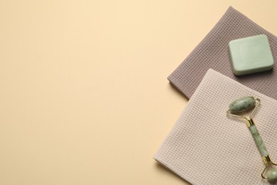 Photo of Clean waffle towels and cosmetic products on beige background, flat lay. Space for text