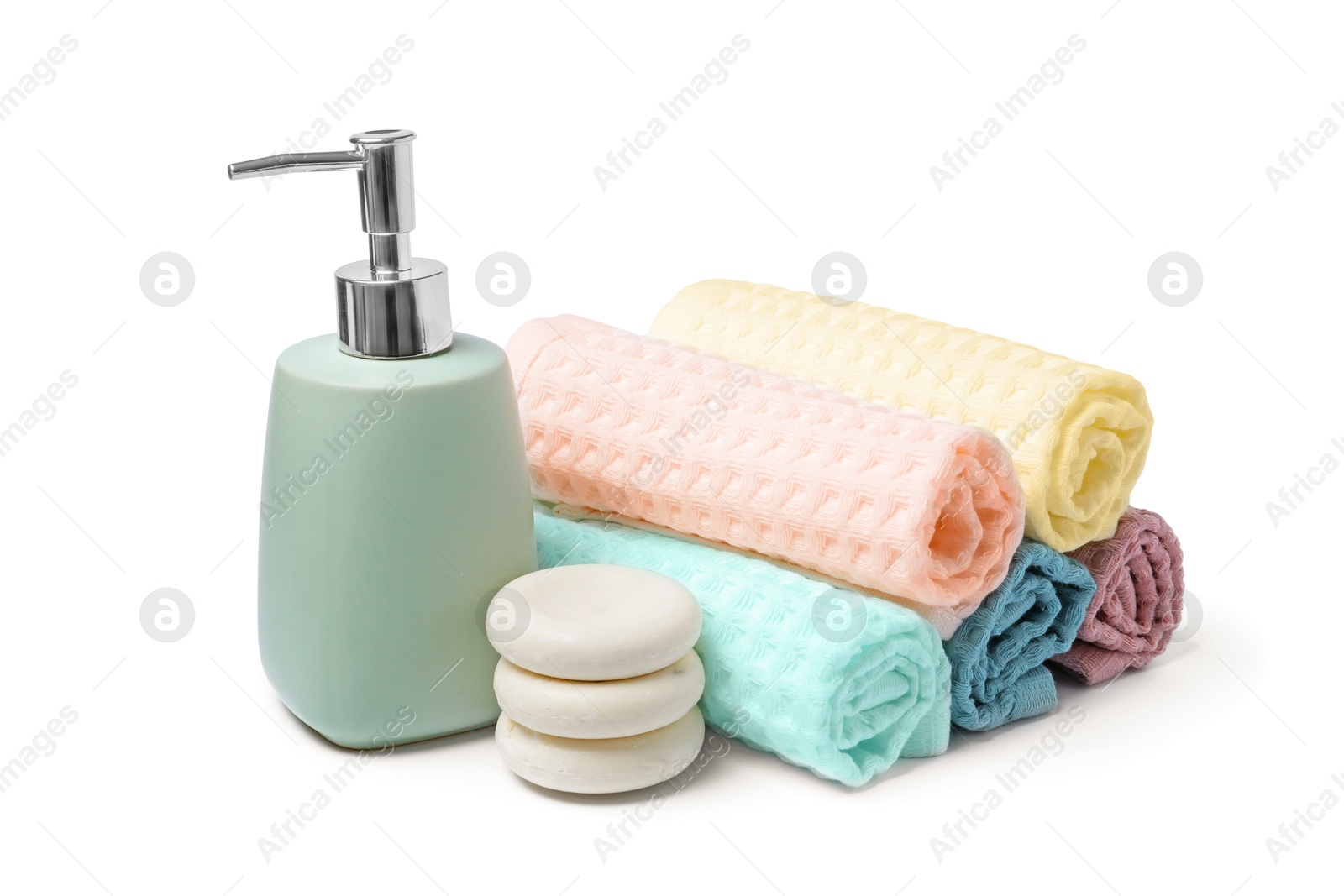 Clean waffle towels, spa stones and soap isolated on white Photo of Clean waffle towels, spa stones and soap isolated on white
