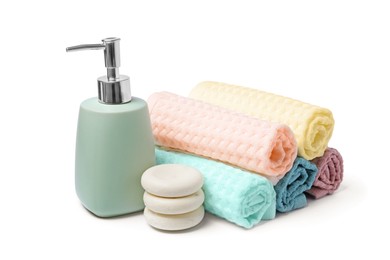 Photo of Clean waffle towels, spa stones and soap isolated on white