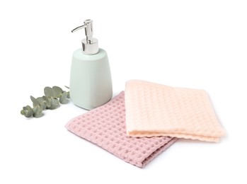 Photo of Clean waffle towels, soap and eucalyptus isolated on white