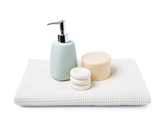 Photo of Clean waffle towel, spa stones and cosmetic products isolated on white