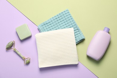 Photo of Clean waffle towels and cosmetic products on color background, flat lay