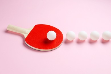 Photo of Ping pong racket and balls on pink background