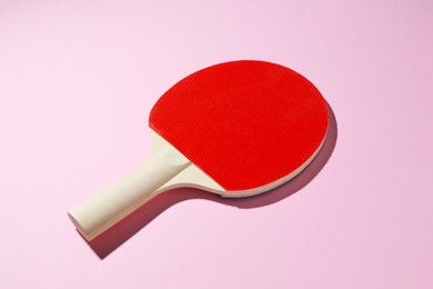 Photo of One ping pong racket on pink background