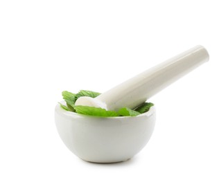 Photo of Fresh lemon balm leaves and pestle in mortar isolated on white