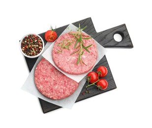 Photo of Fresh raw patties for burger, tomatoes and spices isolated on white, top view